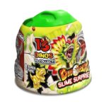 Интерактивна играчка Капсула желе с изненада Динозавър, Craze: жълто-зелена капсула с форма на вулкан, зелен капак като стичащ се слайм, златен тиранозавър и надписи „DinoRex Slime Surprise“ и „15 Dinos to collect!“.