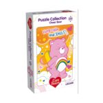 Пъзел Care Bears Cheer, 250 части, Lisciani: бяла кутия с розово мече с дъга на коремчето върху оранжев фон със звездички и надпис „Keep calm and SMILE!“.