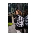 Момиче с къдрава коса носи Ученическа раница CoolPack Rider Flores Jasmine - снимка отстрани