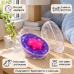 Отворено яйце с лилав слайм и еднорогче на дървена масичка, с надписи за откриване на еднорога, слайм за разтягане и „58 г слайм и фигурка“; продава се 1 брой с цвят изненада.