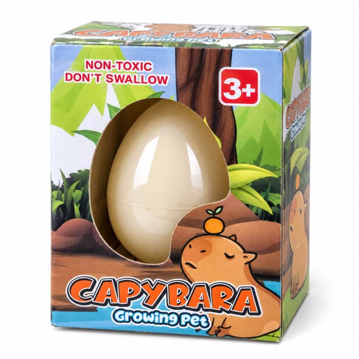 Растящо яйце Капибара: кутия Capybara Growing Pet с рисунка на джунгла и гризач с мандарина на главата, а през прозорчето се вижда кремавата черупка Растящо яйце Капибара: кутия Capybara Growing Pet с рисунка на джунгла и гризач с мандарина на главата, а през прозорчето се вижда кремавата черупка.